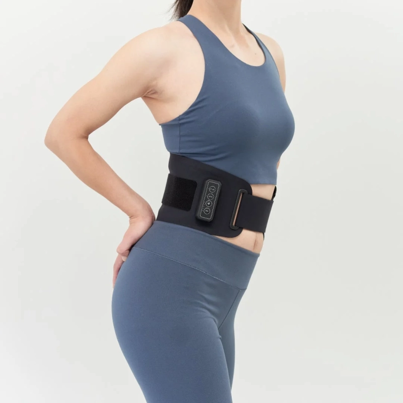 青いスポーツウェアを着用した女性が、腰に黒い骨盤ベルトまたはウエストシェイパーを巻いている